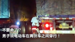 不要命了?男子骑电动车在两货车之间穿行! 不要命了?男子骑电动车在两货车之间穿行!